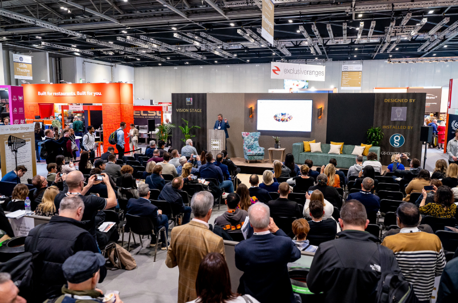 A packed audience engages in a thought-provoking panel discussion on the Vision Stage, exploring key trends shaping the hospitality industry.