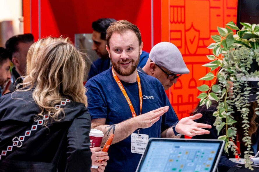 A hospitality expert shares insights with attendees, showcasing new products and services designed to elevate the restaurant and catering experience.