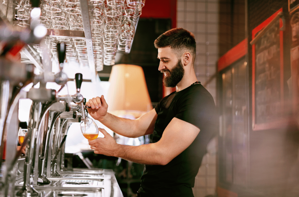 Temporary FOH staff pouring pints behind a Lancashire bar